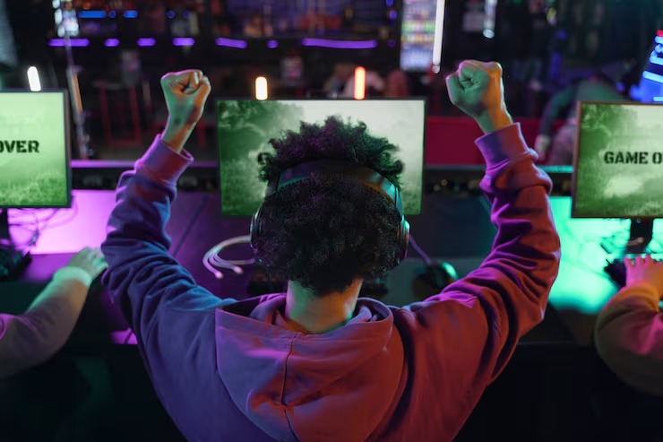 Gamer celebrating victory at esports event after winning a video game match