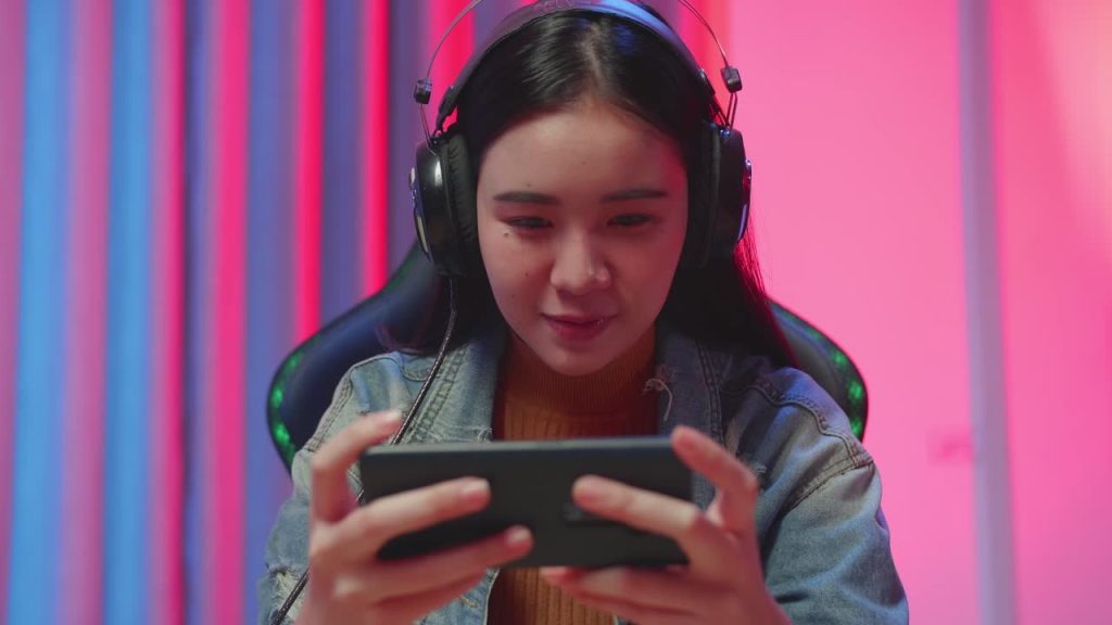 A young creator recording content with a smartphone and ring light, symbolizing the start of a successful streaming career.