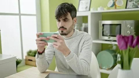 A man play game in mobile phone